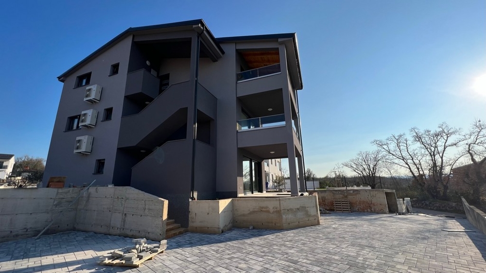 Pohľad na zadnú časť obytnej budovy znázorňujúci pokojnú polohu nehnuteľnosti na ostrove Krk.