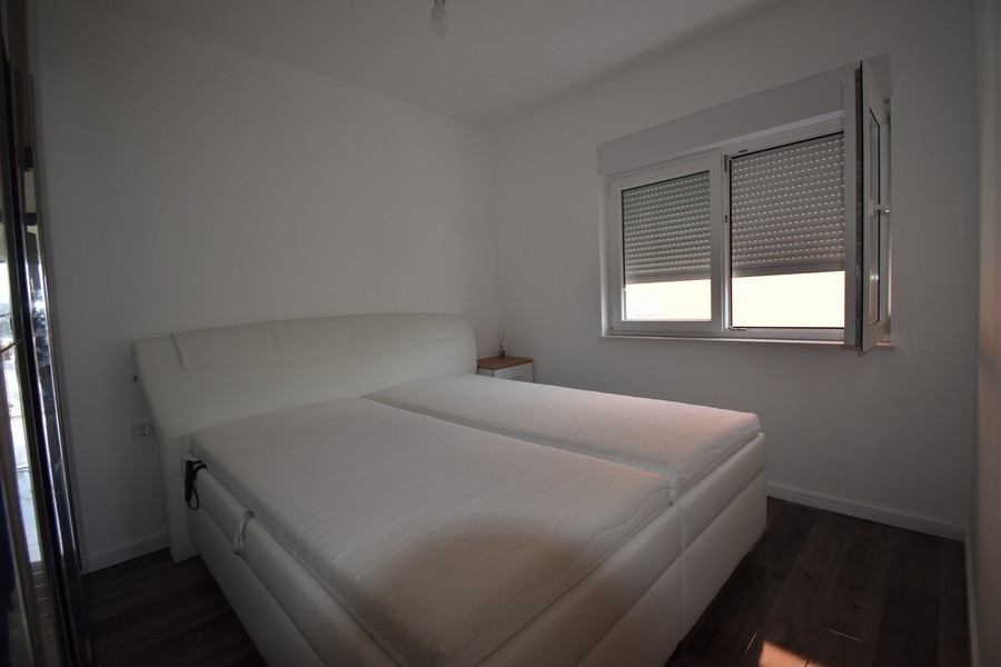 Druhá spálňa s pohodlným zariadením v novom apartmáne, chorvátska nehnuteľnosť