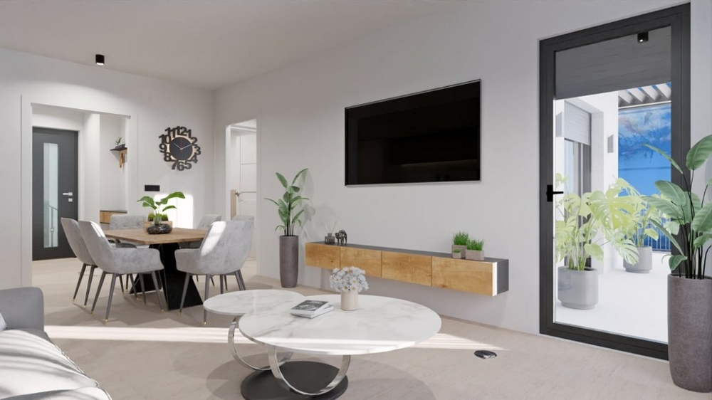 Moderná obývacia izba s jedálenským kútom, TV a prístupom na balkón s výhľadom na more.