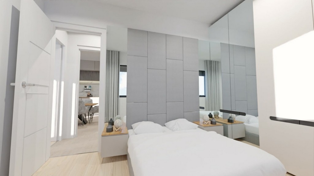 Svetlá spálňa so zrkadlami, bielym nábytkom a prístupom do obývacích izieb.