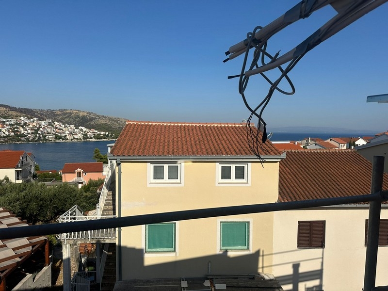 Panoramatický výhľad z balkóna vo výstavbe s výhľadom na susedné domy a pobrežie siahajúce až k obzoru