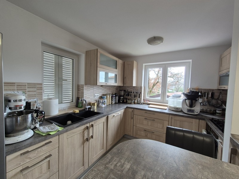 Moderná kuchyňa s drevenými čelami a výhľadom von