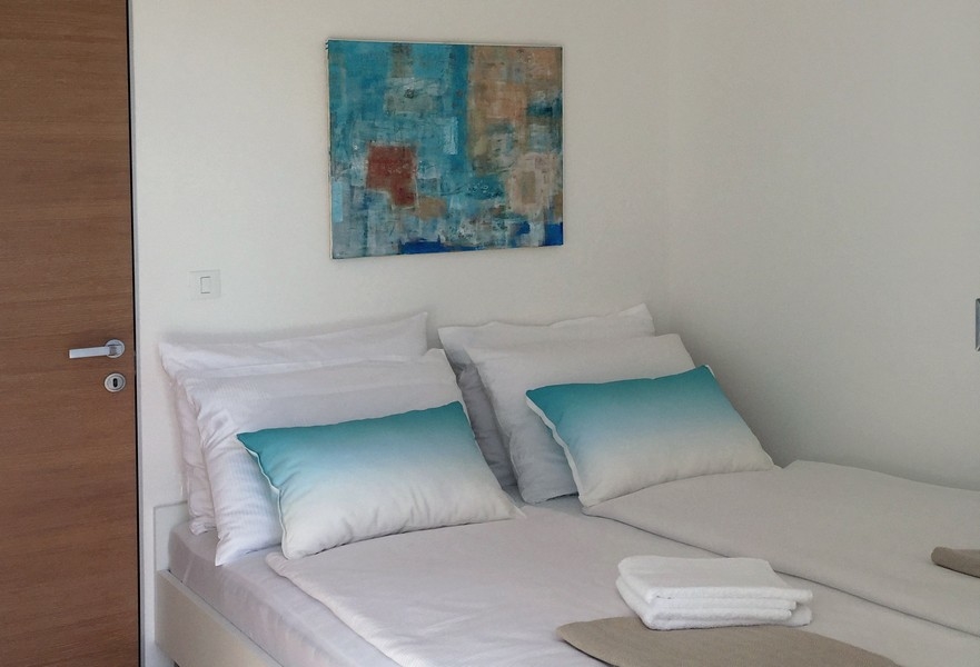 Spálňa s manželskou posteľou a nástennou maľbou