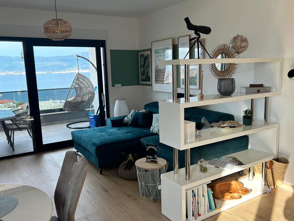 Obývacia izba s výhľadom na more a závesným kreslom