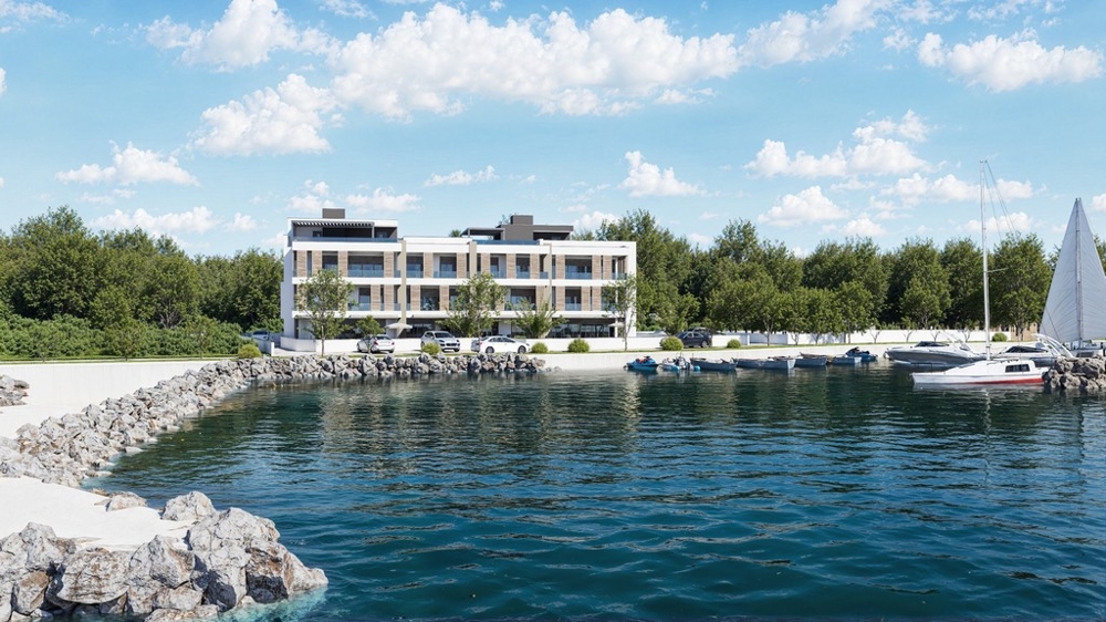 Vizualizácia obytného komplexu s prístaviskom lodí a priamou polohou na mori