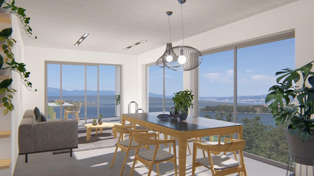 Svetlá obývacia izba s jedálenským kútom a panoramatickým výhľadom na more