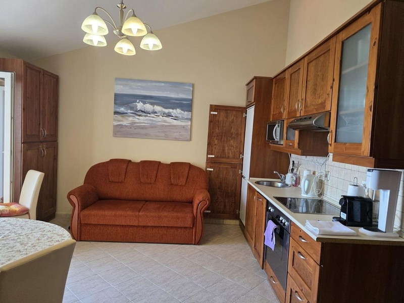 Kuchyňa s jedálenským kútom a pohovkou v podkrovnom byte