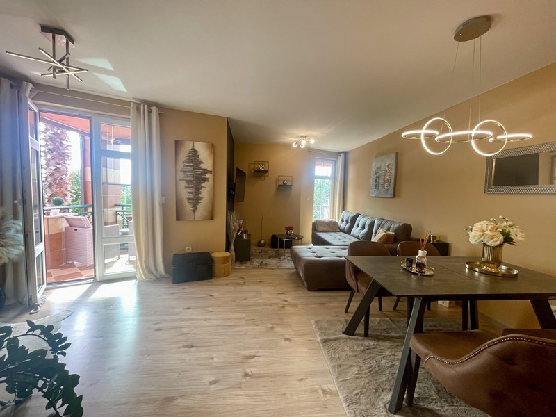 Svetlá obývacia izba s jedálenským kútom, pohovkou a vstupom na terasu