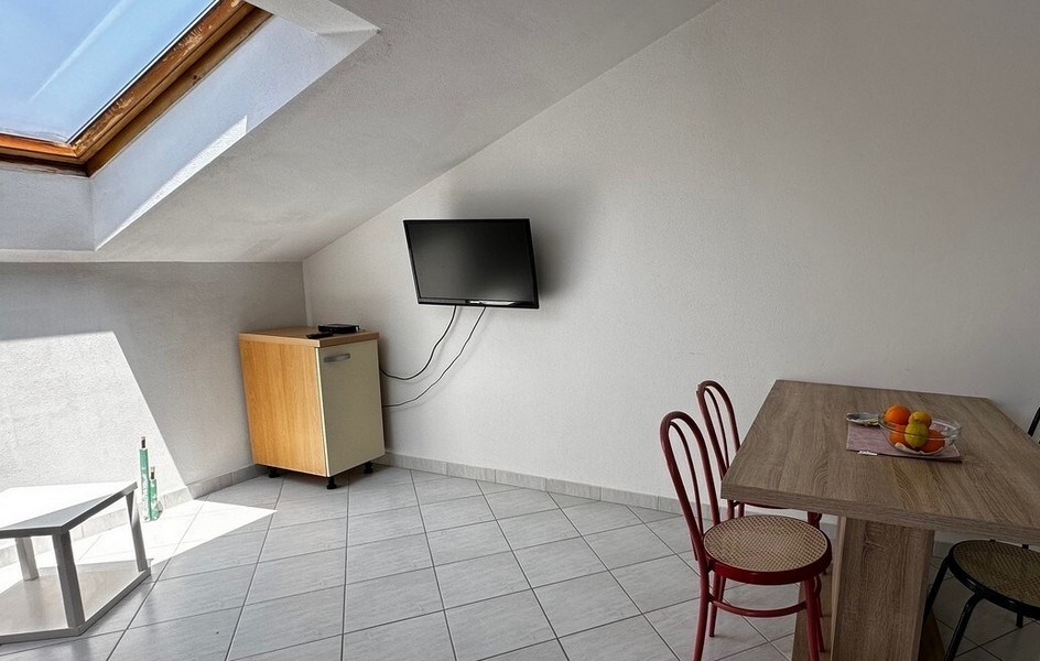 Obývacia izba s TV a jedálenským stolom