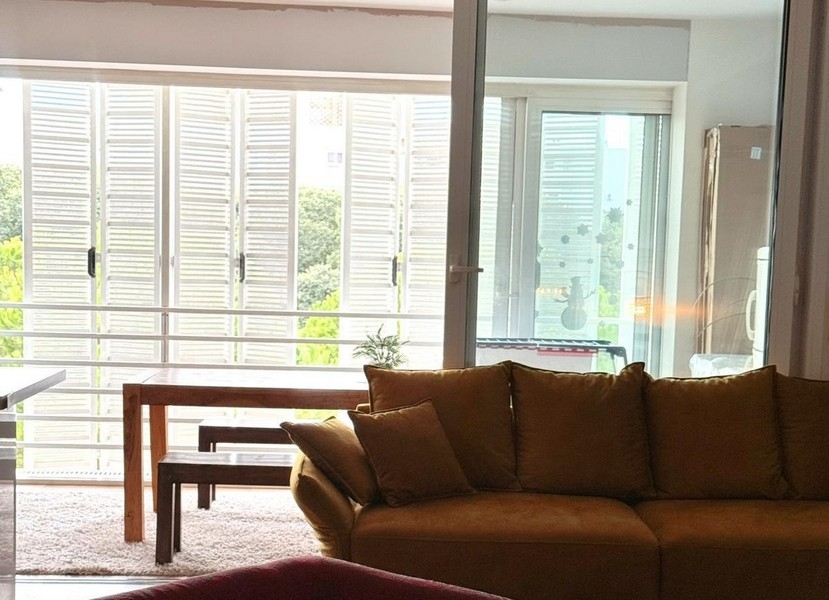 Žltá pohovka pred zasklenou loggiou