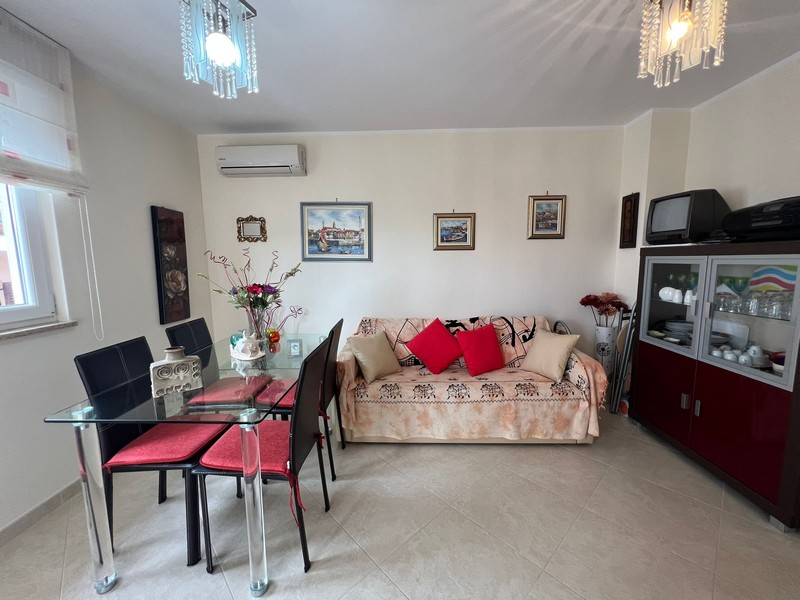 Obývacia izba s pohovkou a skleneným jedálenským stolom