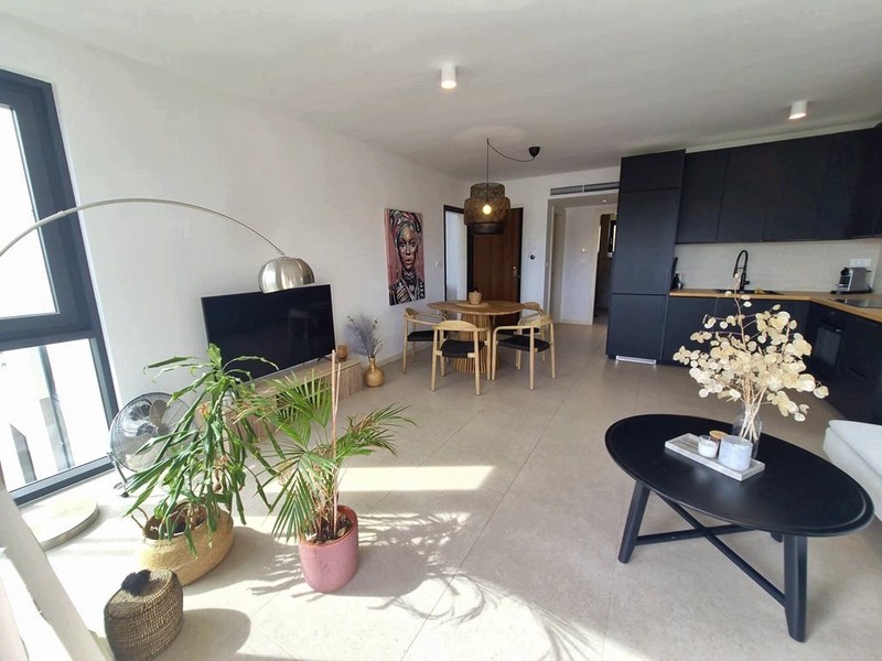 Otvorený obývací priestor s kuchyňou v pozadí