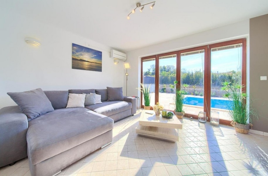 Obývacia izba a výhľad na bazén.