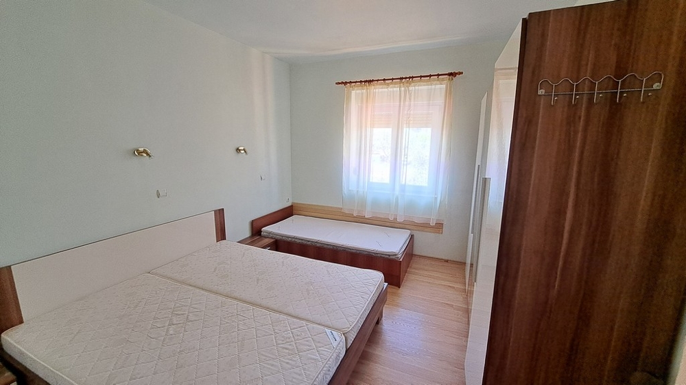 Svetlá spálňa s dvoma lôžkami, vo vnútri prímorskej nehnuteľnosti v Chorvátsku