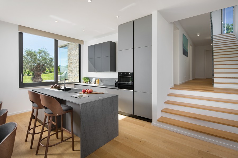 Kuchyňa a barový jedálenský kút plus medziposchodie a schody na horné poschodie.