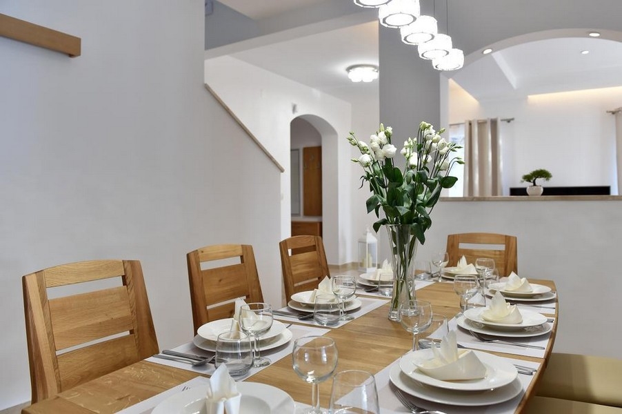 Elegantný jedálenský kút s prestretým stolom a kvetinovým aranžmánom