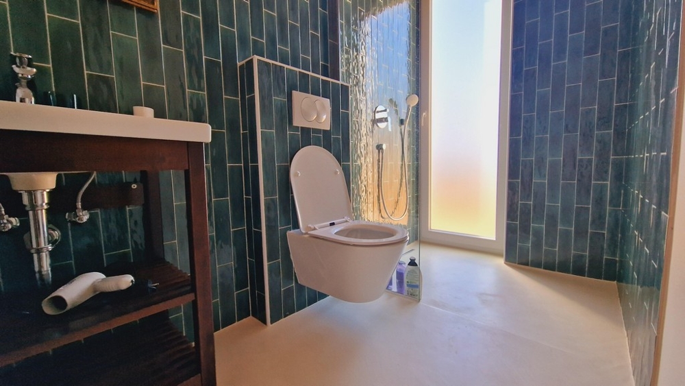 Kúpeľňa so zelenými dlaždicami a otvoreným sprchovacím kútom v nehnuteľnosti H3397 v Chorvátsku.