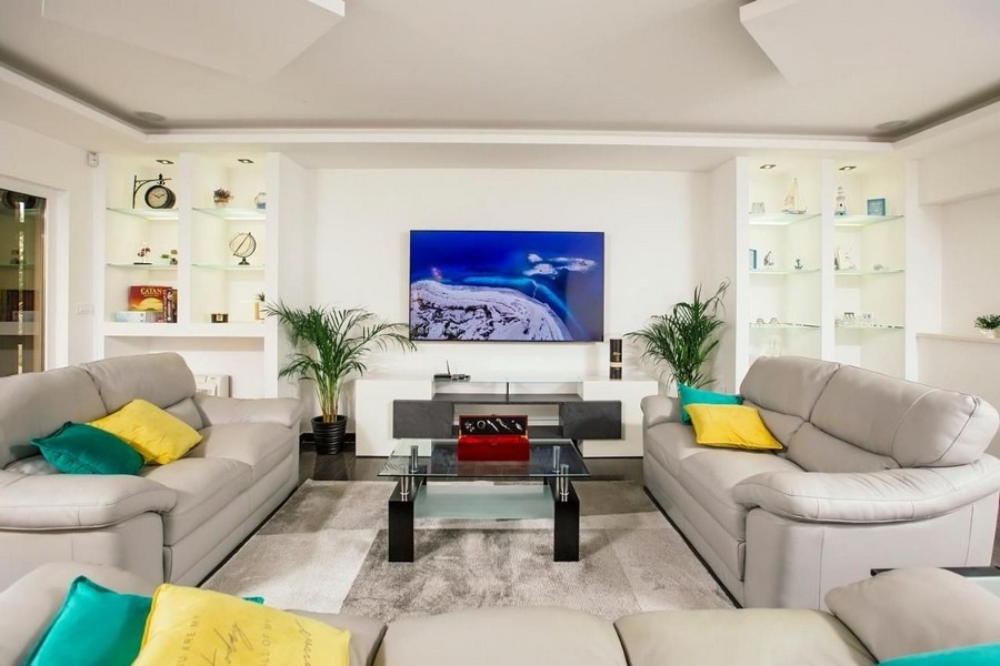 Moderne zariadená obývacia izba s veľkým preskleným priečelím