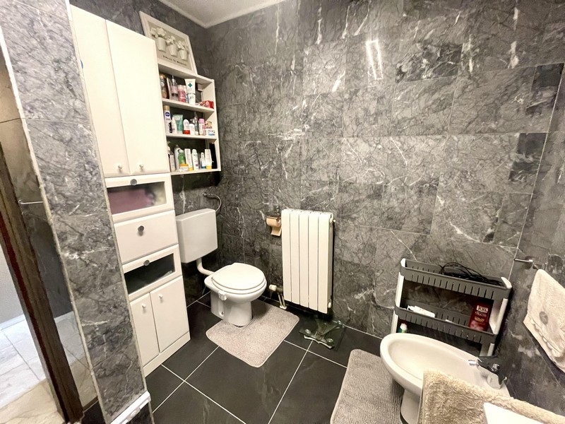 Kúpeľňa s WC, bidetom a sivými obkladmi