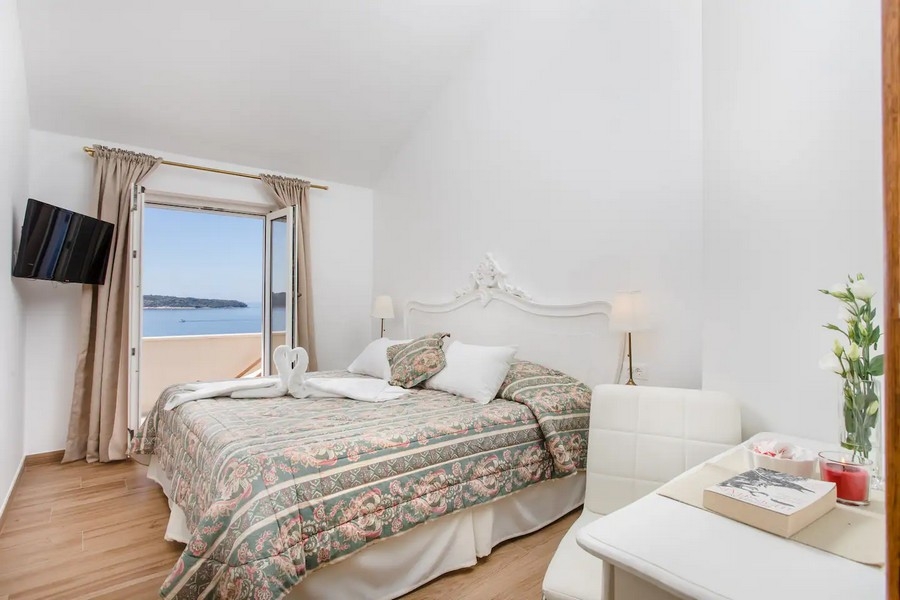 Spálňa s manželskou posteľou a výhľadom na more