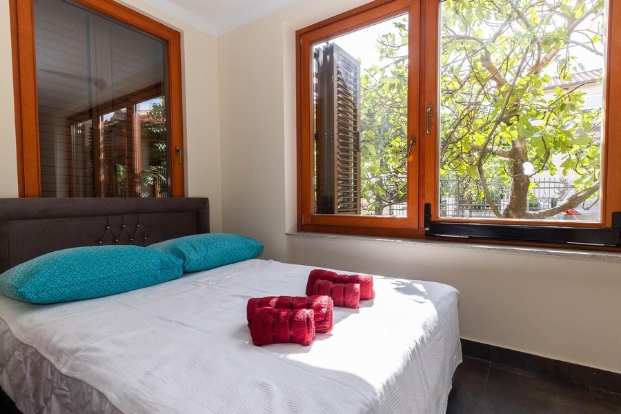 Spálňa s manželskou posteľou a výhľadom do zelene