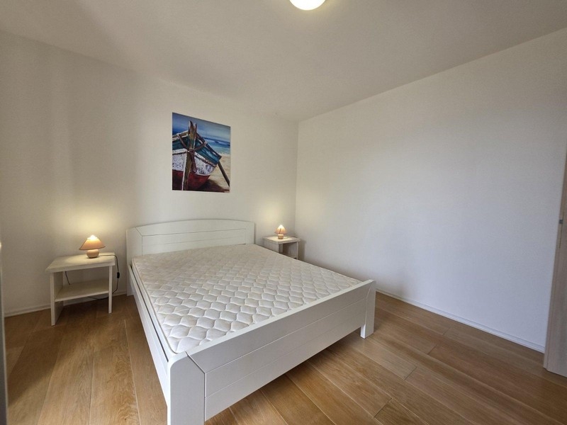 Spálňa s manželskou posteľou a jednoduchým zariadením