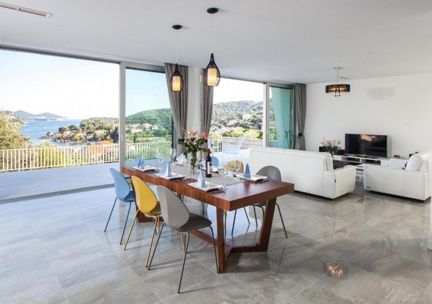 Obývacia izba a jedálenský kút s výhľadom na more v modernej vile neďaleko Dubrovníka