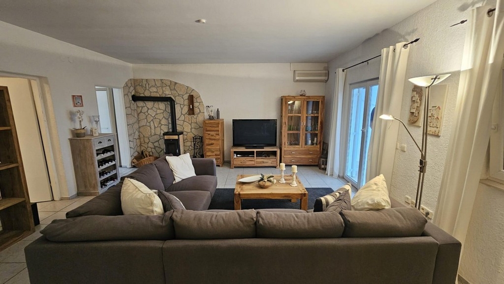 Obývacia izba s pohovkou, TV a krbom