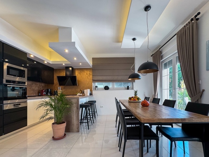 Moderná kuchyňa s jedálenským kútom a veľkým stolom