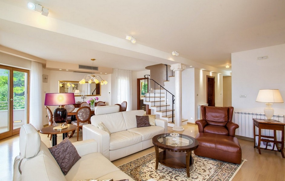 Svetlý obývací priestor s pohovkou a schodiskom