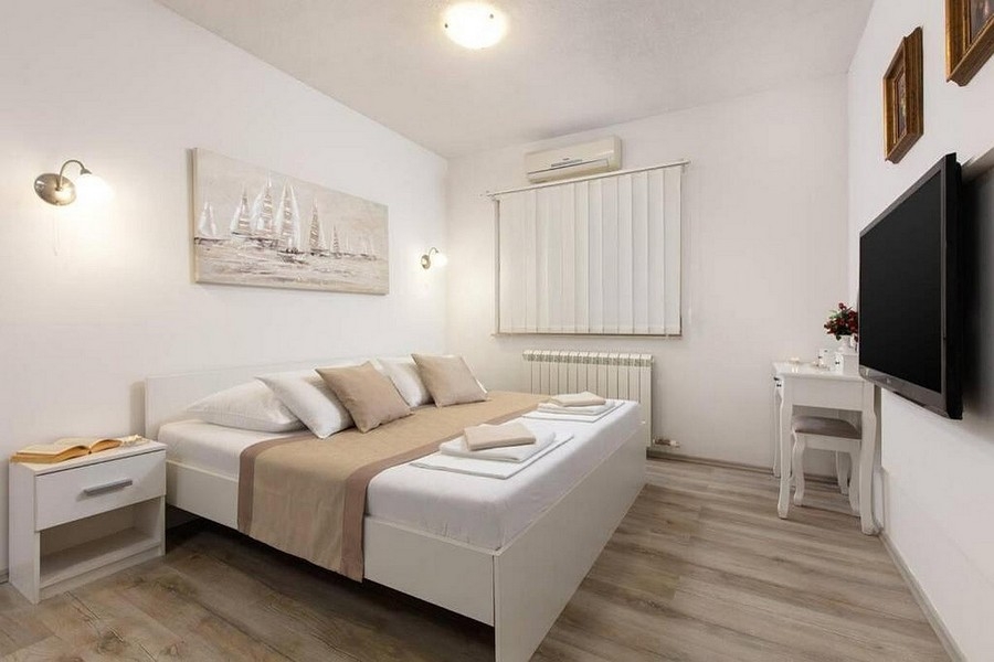Moderne zariadená spálňa s klimatizáciou a TV